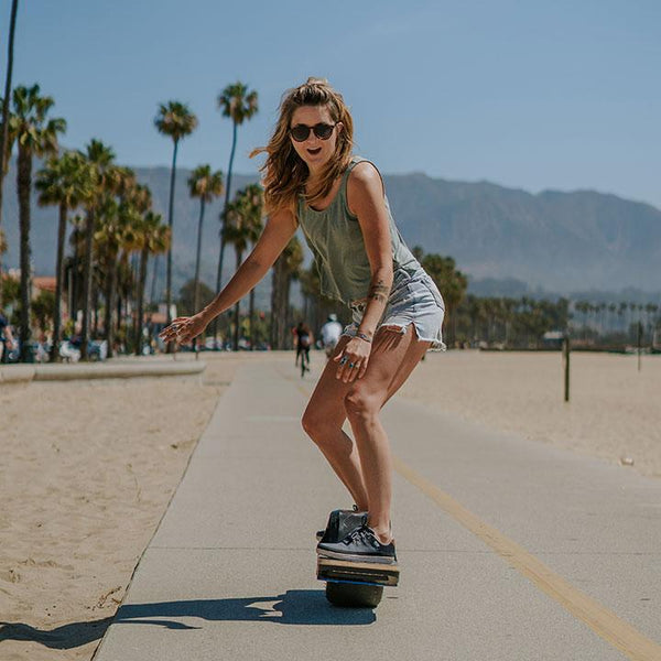 Woman balancing on an E-Board wearing Chillum Varsity Blue Casual Minimal Shoes