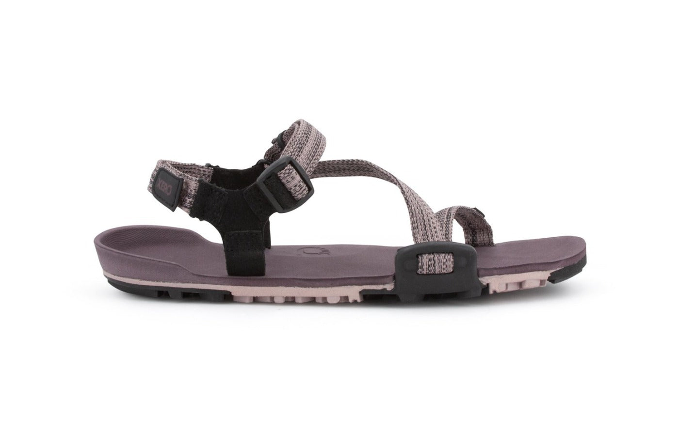 Dusty Rose Z-Trail - flat gray-pink sport sandal with paler pink treads on the bottom. This colourway features gray-pink z-shaped strapping at the front and an adjustable ankle strap at the back. Two black slide buckles are shown at the side of the sandal.