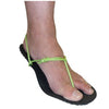 a foot in a Xero Barefoot Shoe with black soles and hot green laces