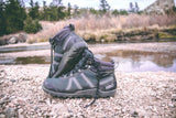 Pair of Spruce Xcursion Fusion HIkers at rocky shallow stream