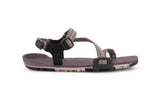 Dusty Rose Z-Trail - flat gray-pink sport sandal with paler pink treads on the bottom. This colourway features gray-pink z-shaped strapping at the front and an adjustable ankle strap at the back. Two black slide buckles are shown at the side of the sandal. 