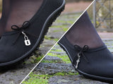 Two-Part image shows the left and right shoes in the pair of Leguano Lady Loop. One shoe has a small bow with a metallic padlock charm and the other has a small bow with a metallic key charm