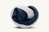 Primal 2 Eclipse -dark blue and white shoe, rolled up lengthwise to show the flexibility of the sole.