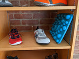 Blue Rox mat on a shelf beside shoes to show scale