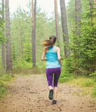 Person running in the woods in Xero Lightweight Minimal TerraFlex Trail Runner