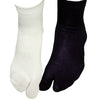 One white and one black tabi ankle socks on feet