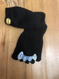 A vibram Merino Wool Crew Length Five-Toe sock is posed with the toes threaded through a pair of Correct Toes Toe spreaders