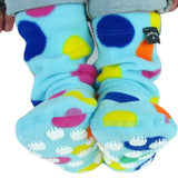 Cozy fleece non-slip socks for children in turquoise with multi coloured polkadots. Non-slip material on bottom features white bear pawprint pattern