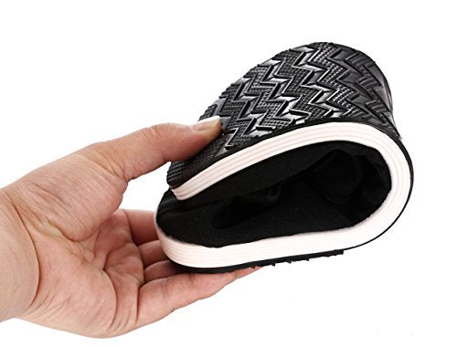 Black rubber-soled gongfu shoe folded in half to show flexibility